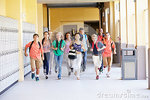 group-high-school-students-running-along-corridor-towards-camera-looking-happy-41534156